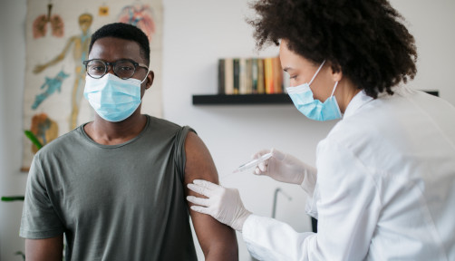 black patient man getting vaccine face mask covid coronavirus